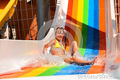 Child in bikini sliding water park Stock Photo
