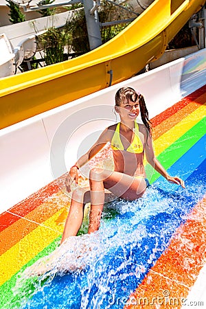 Child in bikini sliding water park Stock Photo