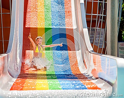 Child in bikini sliding water park Stock Photo