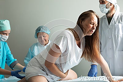 Child birth process, helping personal during labour Stock Photo