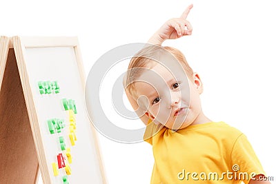 Child at the blackboard, numbers and letters makes up words. Stock Photo