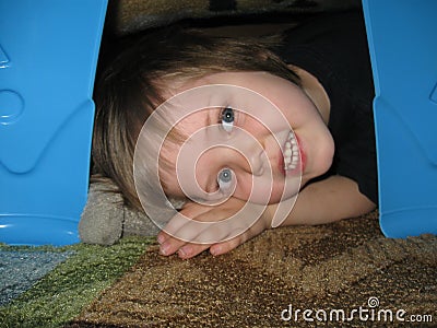 Child in blanket fort