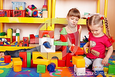 Child with block in play room. Stock Photo