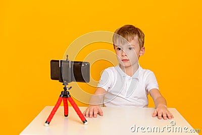 A child blogger records a video message to his subscribers Stock Photo