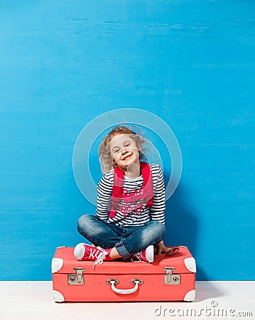 Child blonde girl with pink vintage suitcase ready for summer vacation. Travel and adventure concept Stock Photo