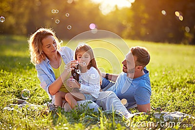 Child blow soup foam and make bubbles in nature Stock Photo