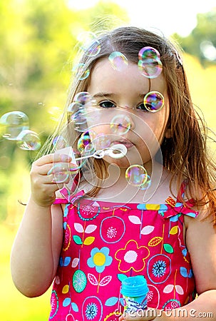 Young girl blowing bubbles Stock Photo