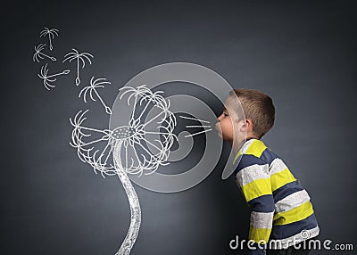Child blowing dandelion seeds Stock Photo