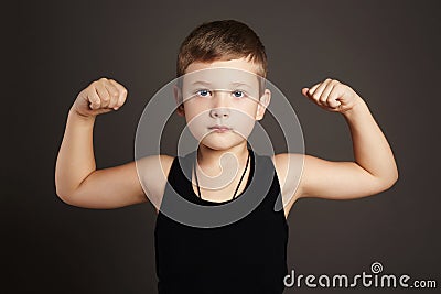 Child.Funny Little Boy showing his muscles Stock Photo