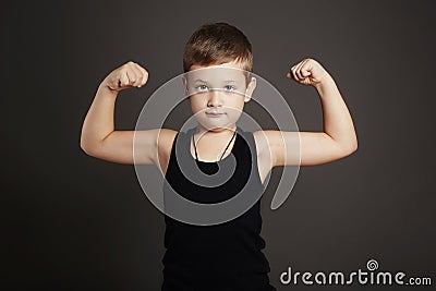 Child.Funny Little Boy showing his muscles Stock Photo