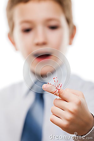 Child boy looking at finger tied string knot memory reminder Stock Photo