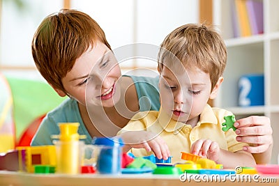 Child boy and mother playing colorful clay toy Stock Photo