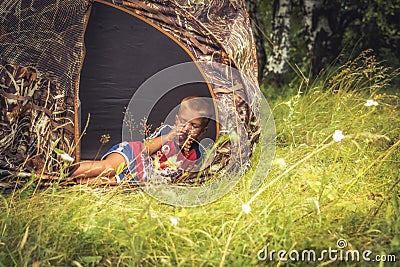 Child boy resting in camping tent in countryside summer camp concept childhood camping countryside lifestyle Stock Photo
