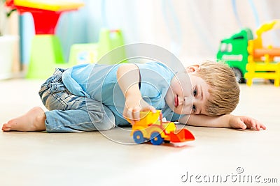 Child boy toddler playing with toy car Stock Photo