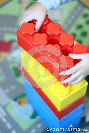 The child builds a tower out of bricks constructor Stock Photo