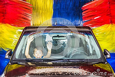 Child in car at carwash Stock Photo