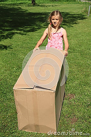 Child carrying a box Stock Photo