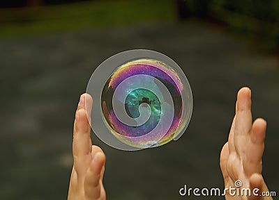 Child catching the soap bubble Stock Photo