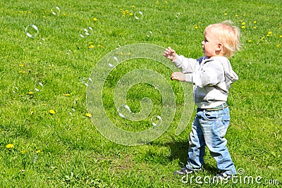 Child catching soap bubbles Stock Photo