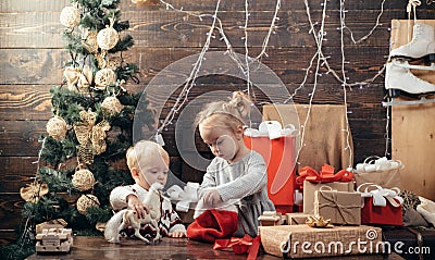 Child with a Christmas present on wooden background. Winter kids. Kid enjoy the holiday. Christmas card. New year kids Stock Photo