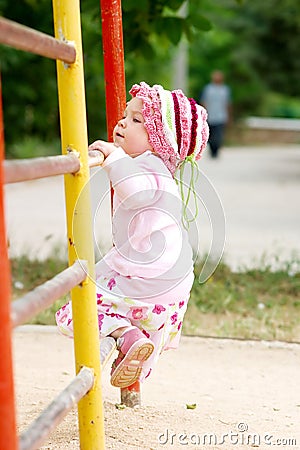 Child climbing on bars Stock Photo