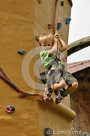 Child climbing down wall Stock Photo
