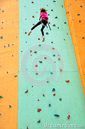 Child climbing down the wall Stock Photo