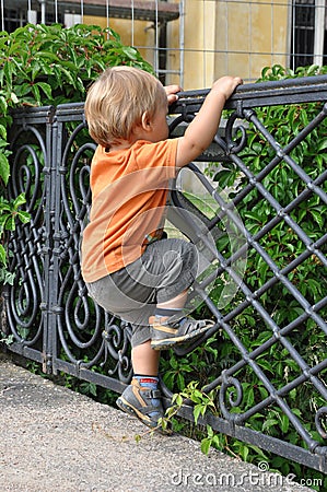 Child climbing fence Stock Photo