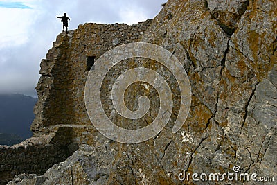 A child climbing on a hight rock wall Stock Photo