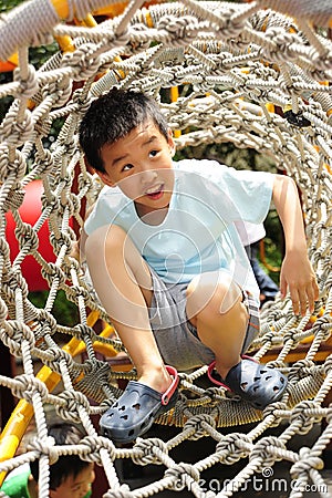 A child climbing a jungle gym. Stock Photo