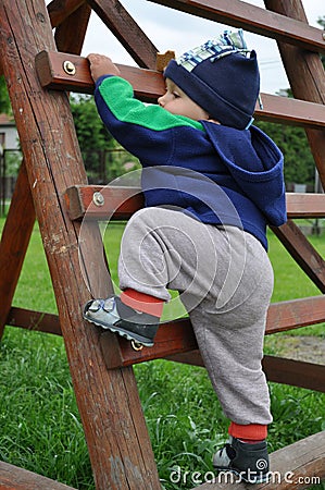 Child climbing step ladder Stock Photo