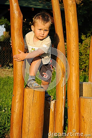 Child climbing wooden steps Stock Photo