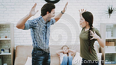 Man Screams Woman in Apartment Child Closes Ears. Stock Photo
