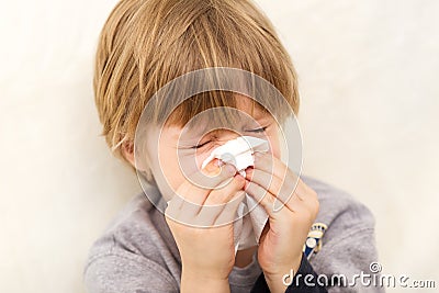 Child cold flu illness tissue blowing runny nose Stock Photo