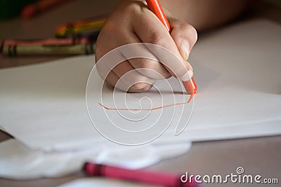 Child Coloring on Blank White Paper with Color Crayons Stock Photo