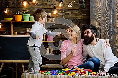 Child concept. Child development. Child play with brick toys. Little child with mother and father build structure with Stock Photo