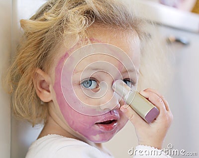 Child covered in lipstick Stock Photo