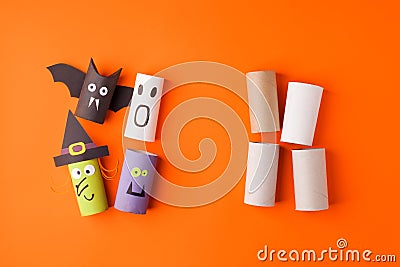 Child creates decorations for Halloween party from toilet roll. Easy eco-friendly DIY master class, craft for kids. Materials for Stock Photo