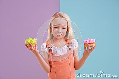 Child, cupcake and portrait for colorblock in studio for dessert, pastry and icing for sugar, cake and frosting. Little Stock Photo