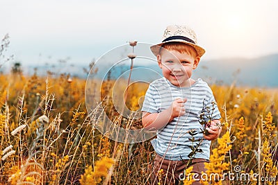 Child cute boy with the hat on nature at sunset Stock Photo