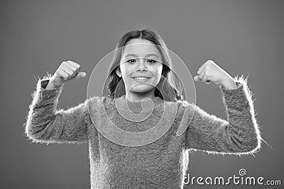 Child cute girl show biceps gesture of power and strength. Feel so powerful. Girls rules concept. Upbringing advices for Stock Photo