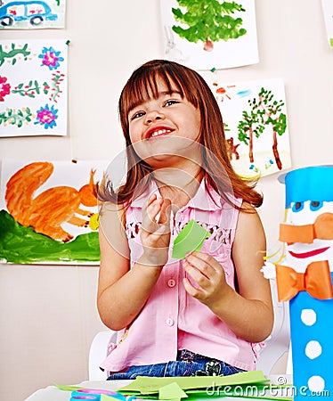 Child cutting paper by scissors. Stock Photo