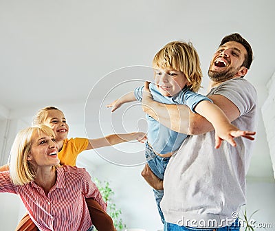 child daughter son family happy mother father sofa playing fun together girl boy cheerful smiling home together Stock Photo