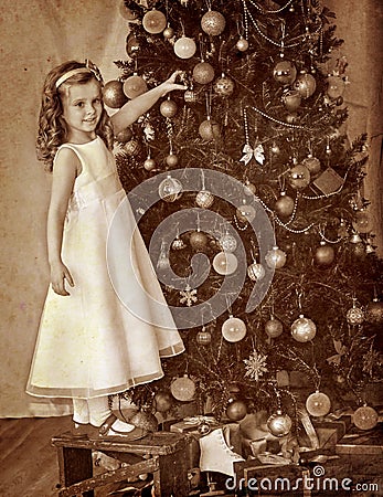 Child decorate on Christmas tree Stock Photo