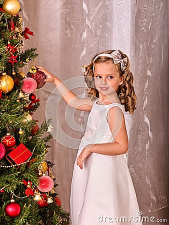 Child decorate on Christmas tree. Stock Photo