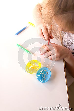 Child decorate Easter eggs Stock Photo