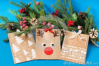 Child decorates craft gift bags for Christmas. Step 9 Stock Photo