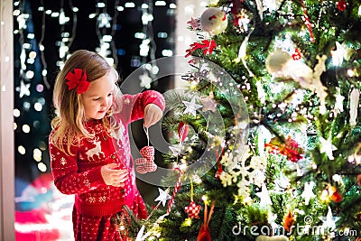 Child decorating Christmas tree Stock Photo