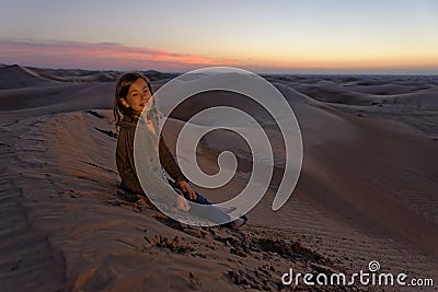 Child in desert at sunset Stock Photo