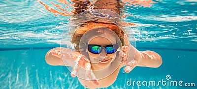 Child dives into the water in swimming pool. little kid swim underwater in pool. Child swimming underwater in sea or Stock Photo